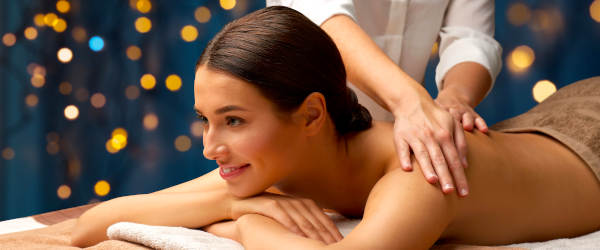 Woman Lying And Having Back Massage At Spa St Moritz Wellness