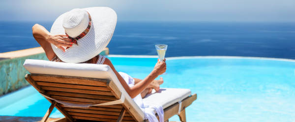A Elegant Woman In White Dress And Hat Relaxes With A Glass Of C Escort Lady Sardinia